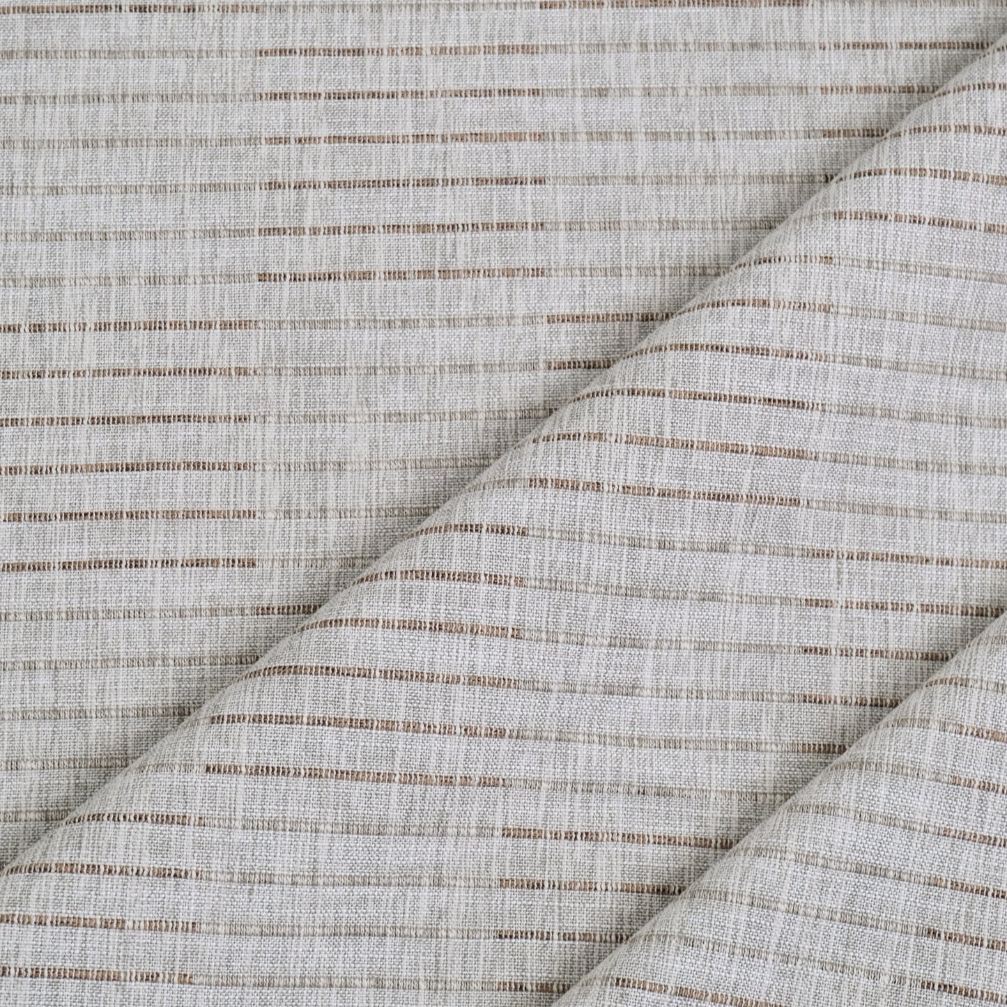 a close-up view of a fabric with a diagonal pattern of brown and white stripes. The fabric appears to be made of a woven material, with a textured and woven appearance.