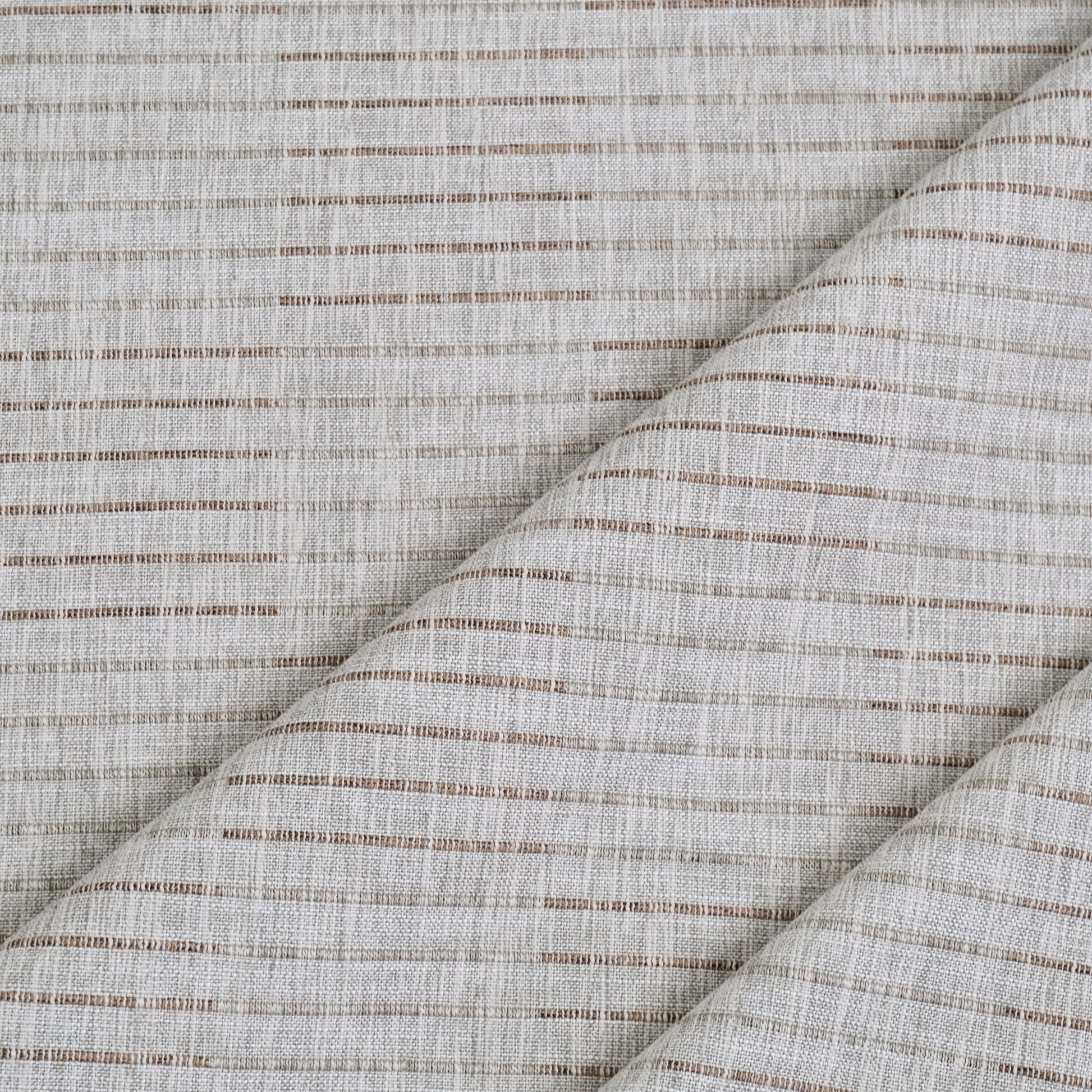 a close-up view of a fabric with a diagonal pattern of brown and white stripes. The fabric appears to be made of a woven material, with a textured and woven appearance.