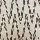 a close-up view of a fabric with a repeating pattern of diagonal lines in varying shades of brown. The fabric appears to be made of a woven material, and there is a ruler placed in front of it for scale.