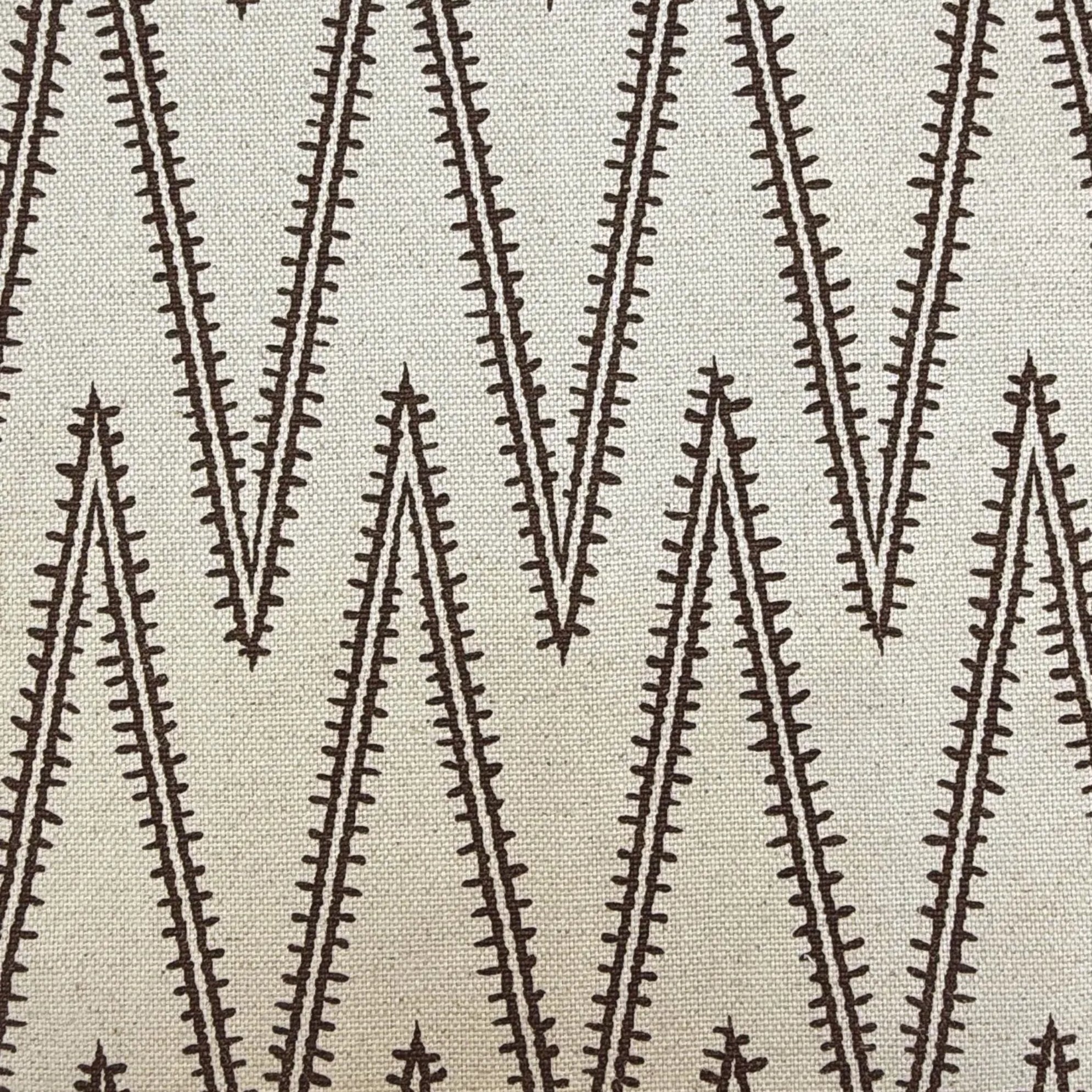 a close-up view of a fabric with a repeating pattern of diagonal lines in varying shades of brown. The fabric appears to be made of a woven material, and there is a ruler placed in front of it for scale.