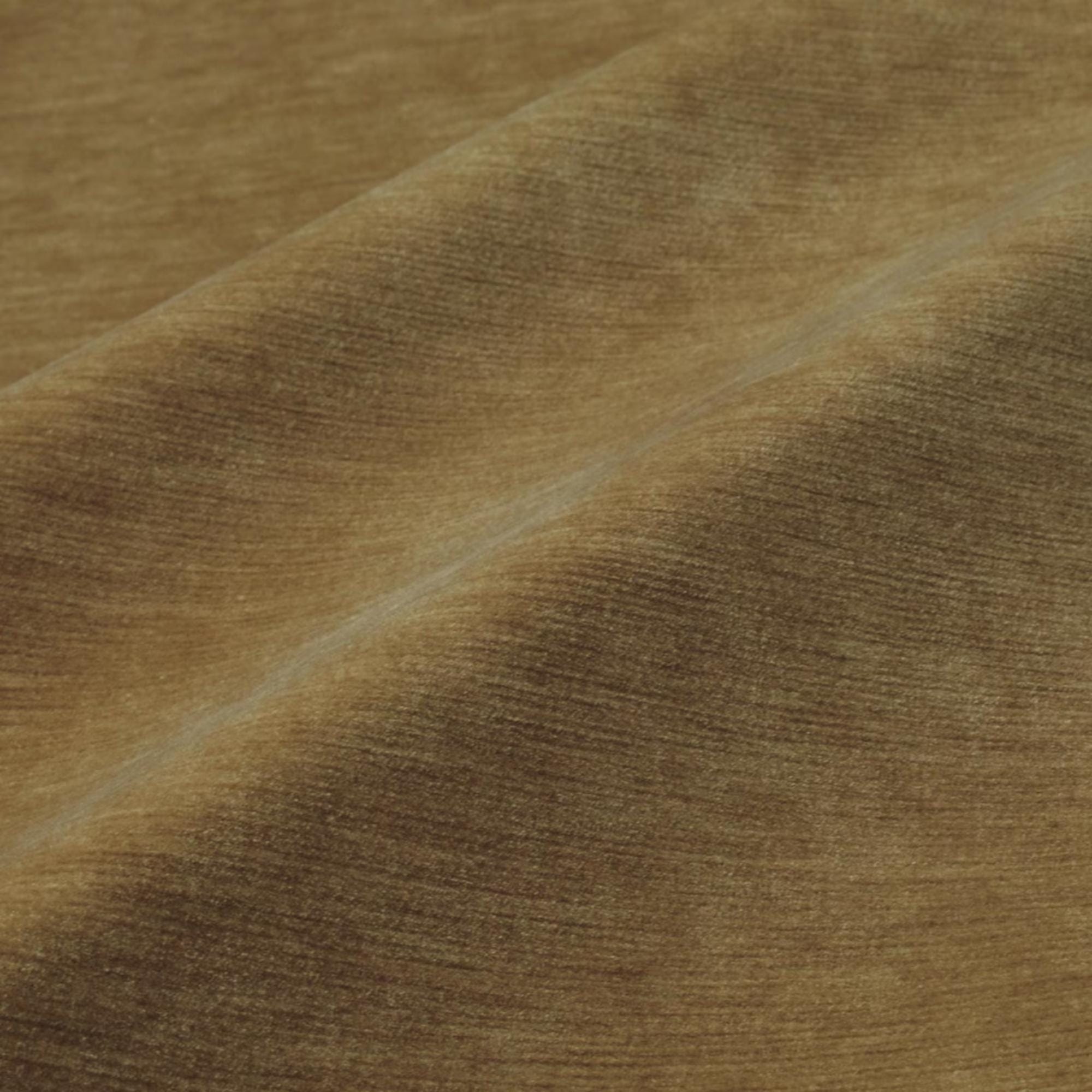 a close-up view of a textured fabric, possibly a piece of clothing or a textile. The fabric appears to be brown in color and has a criss-cross pattern, giving it a somewhat wrinkled appearance.