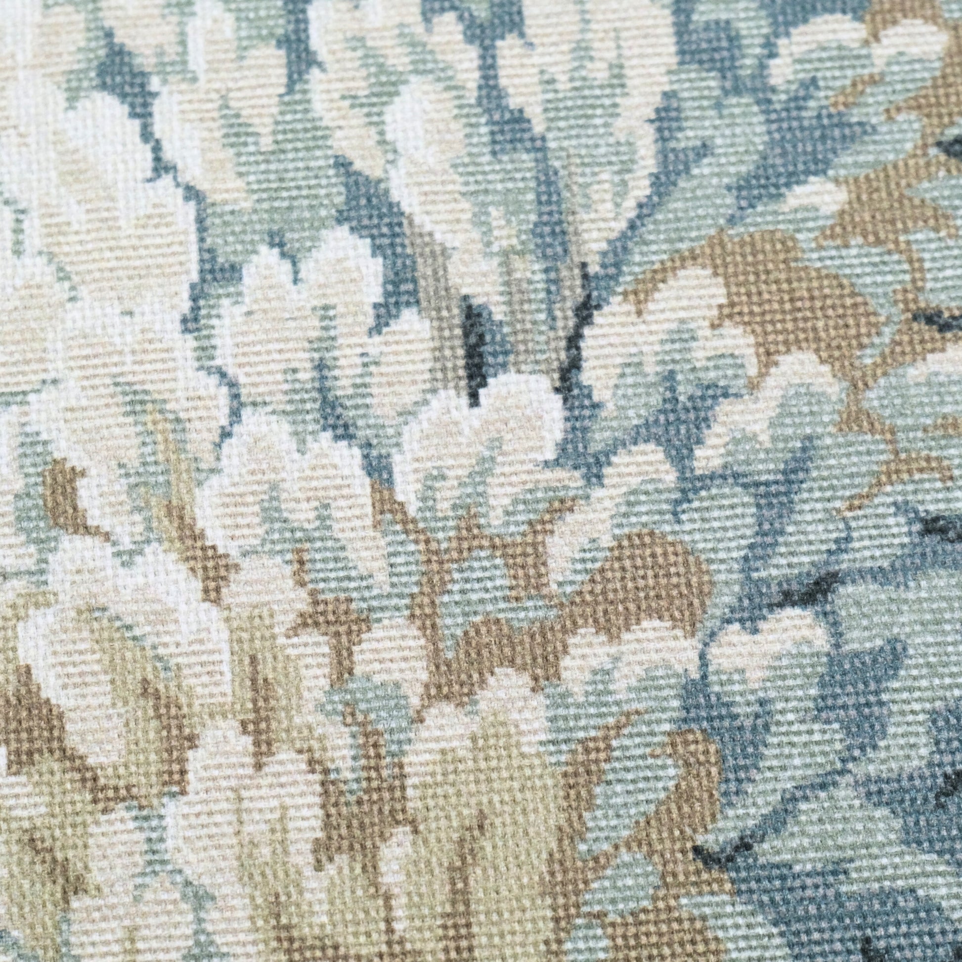 The image is a close-up of a fabric with a floral pattern, featuring a mix of light and dark green and beige colors.