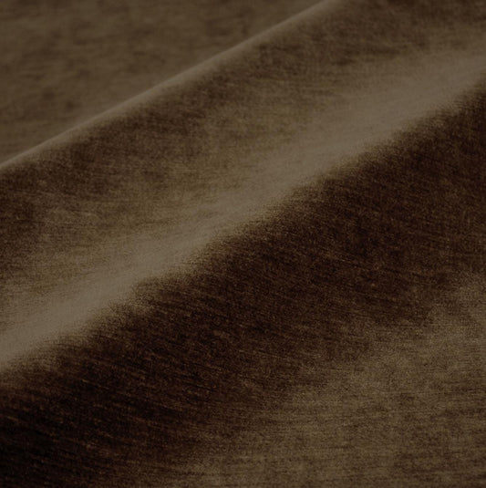 a close-up view of a brown fabric, possibly velvet, with a textured and wrinkled appearance.