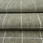 a close-up view of a textured fabric with a checkered pattern, featuring a repeating diagonal line design.