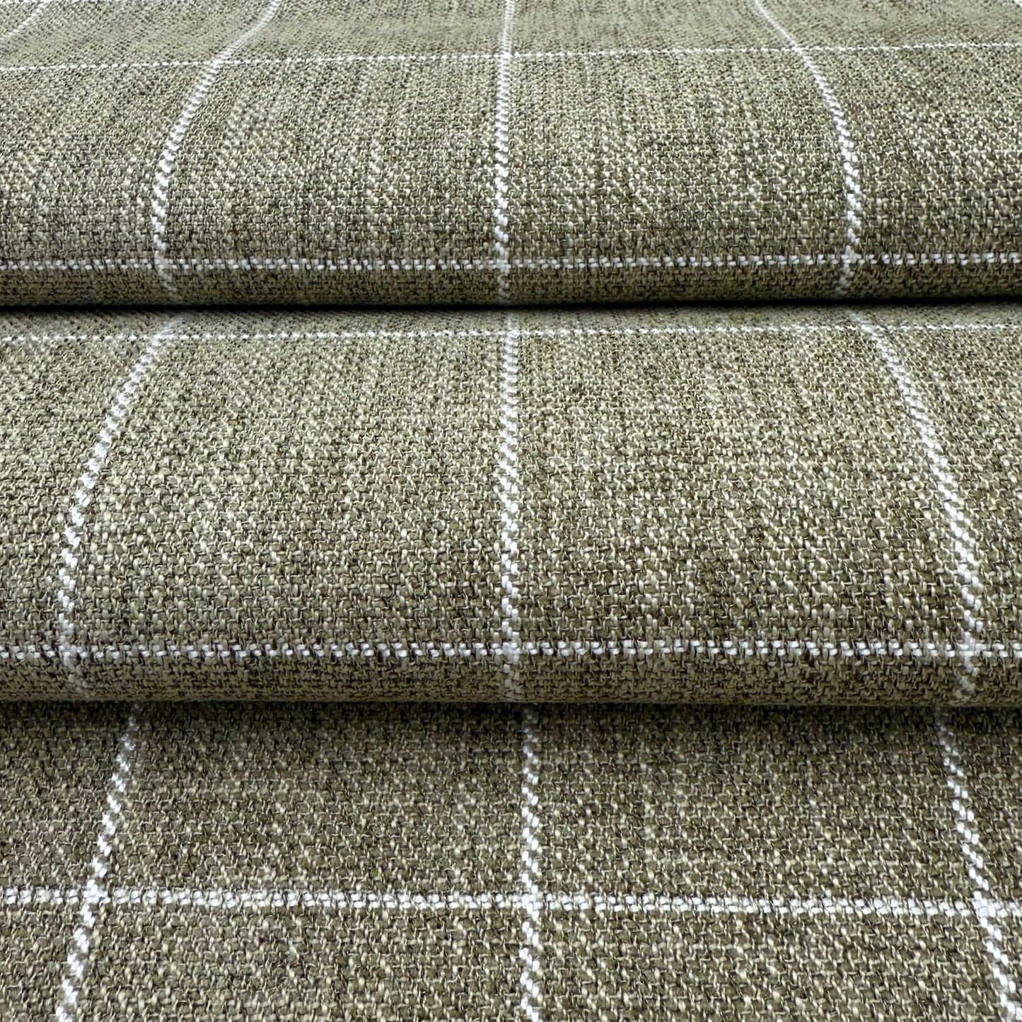 a close-up view of a textured fabric with a checkered pattern, featuring a repeating diagonal line design.