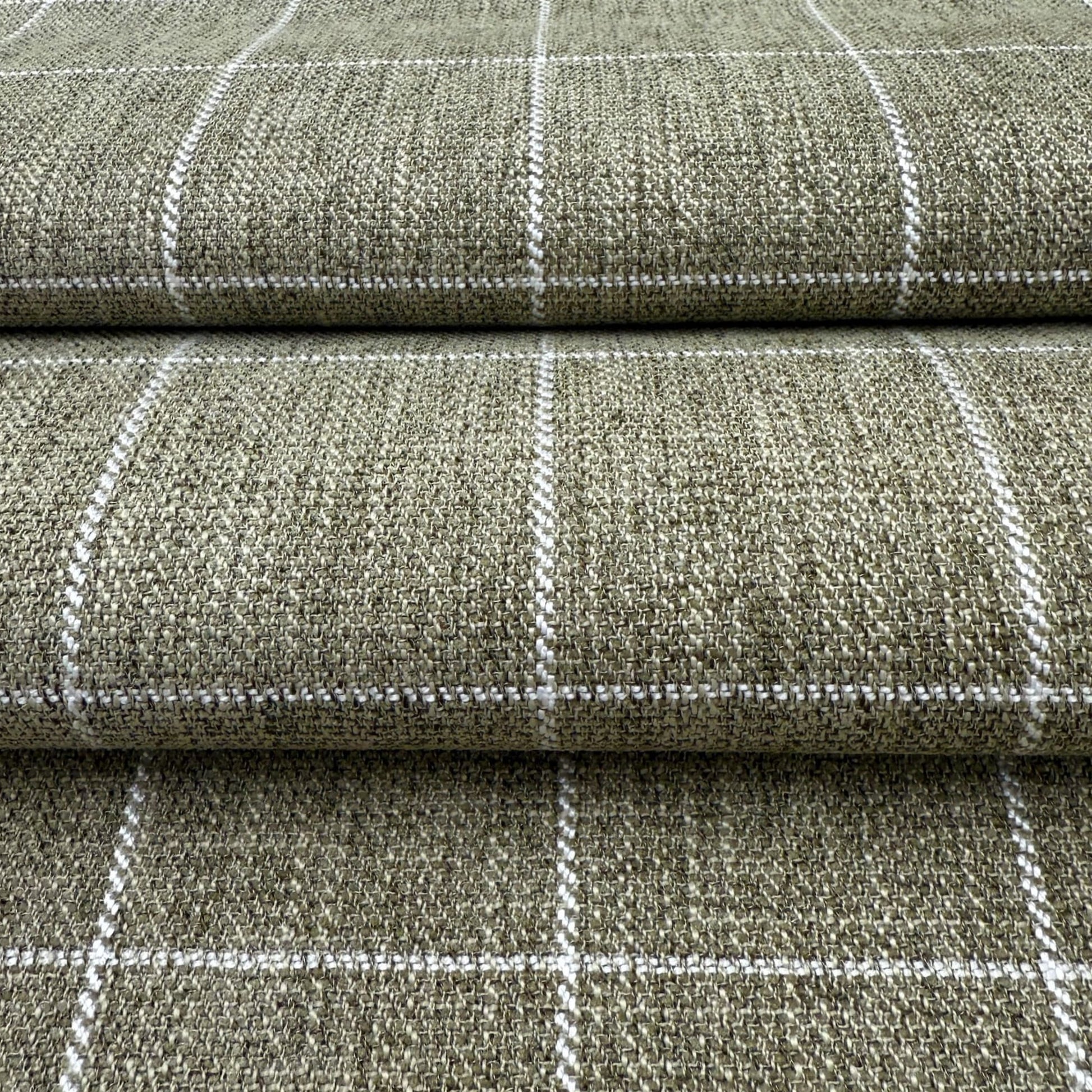 a close-up view of a textured fabric with a checkered pattern, featuring a repeating diagonal line design.