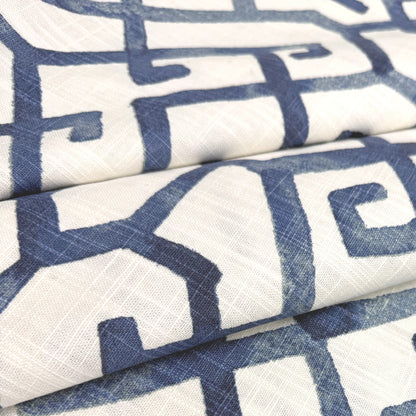 a close-up view of a fabric with a repeating pattern of blue and white geometric shapes, creating a visually striking and intricate design.