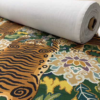 Emerald green tiger fabric on a bolt, illustrating how the textile is cut to order by the yard.