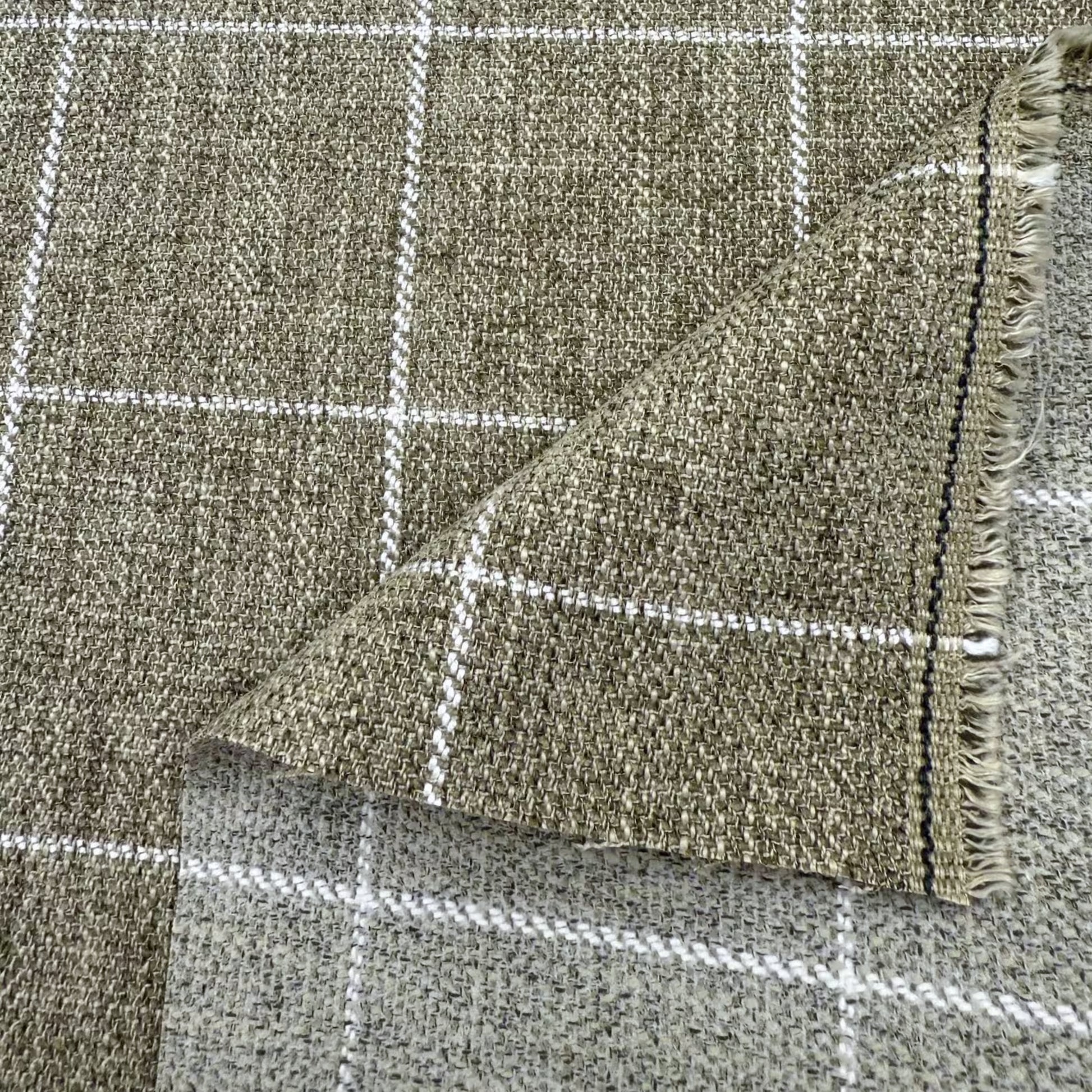 a close-up view of a woven fabric with a checkered pattern. The fabric appears to be a neutral-colored material, possibly a type of textile or upholstery.