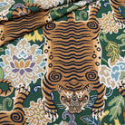 A close-up view of the emerald green tiger fabric draped to show how the pattern looks on curved furniture or pillows.