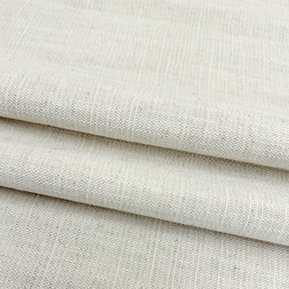Soft drapes of natural cream slub linen fabric perfect for custom curtains and home decor.