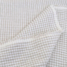 Textured gingham check fabric in beige and white, ideal for cushions and table linens