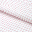 a close-up view of a fabric with a pink and white checkered pattern.