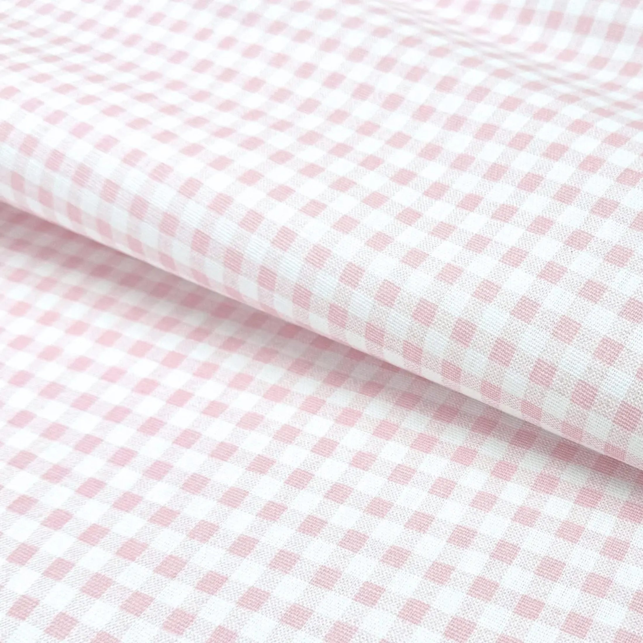 a close-up view of a fabric with a pink and white checkered pattern.