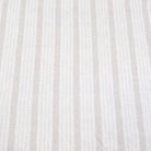 Flat lay of taupe striped linen fabric showing even balanced stripes and neutral color tones. The fabric’s light drape makes it perfect for farmhouse style drapery, rustic table runners, DIY napkins, and cottage-style crafts. This striped linen is a versatile choice for sewing enthusiasts looking to create timeless, minimalist home décor items with natural linen texture and neutral earthy stripes.