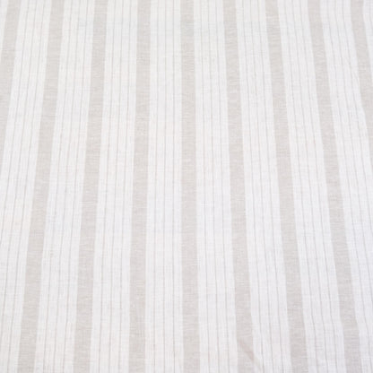 Flat lay of taupe striped linen fabric showing even balanced stripes and neutral color tones. The fabric’s light drape makes it perfect for farmhouse style drapery, rustic table runners, DIY napkins, and cottage-style crafts. This striped linen is a versatile choice for sewing enthusiasts looking to create timeless, minimalist home décor items with natural linen texture and neutral earthy stripes.