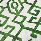 a close-up view of a fabric with a repeating pattern of green geometric shapes, creating a visually striking and intricate design.