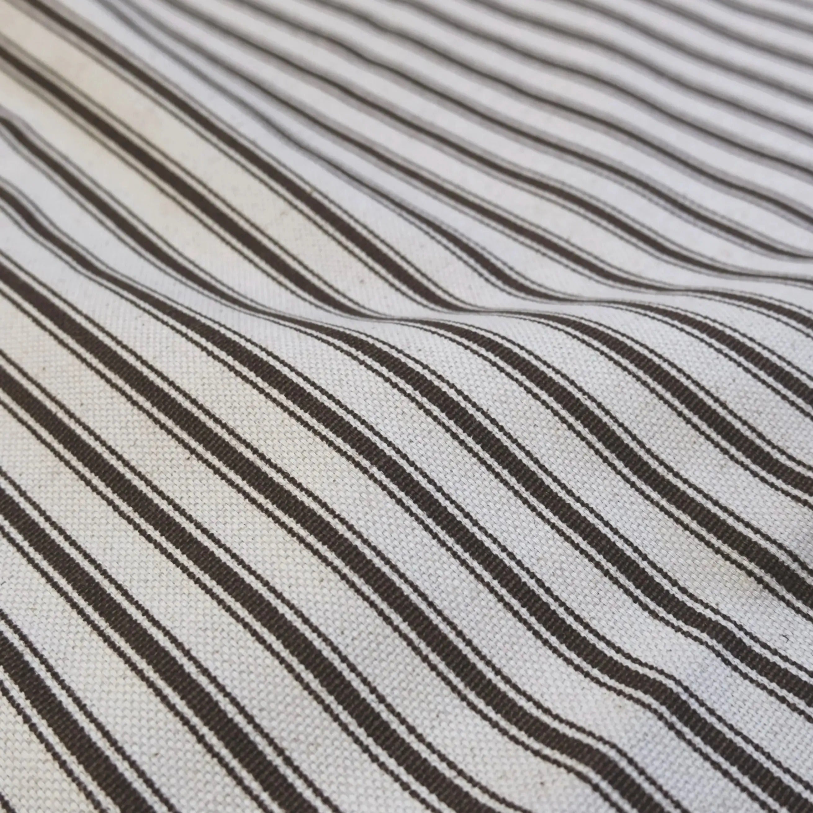 A close-up view of a fabric with diagonal black and white stripes.