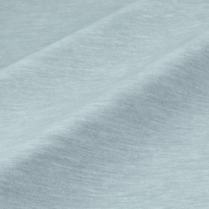 a close-up view of a textured fabric, possibly a piece of clothing or a textile. The fabric appears to be a light blue color, with a slightly wrinkled and folded appearance. The image does not contain any discernible objects or actions, and there are no specific actions or objects that can be described in detail.