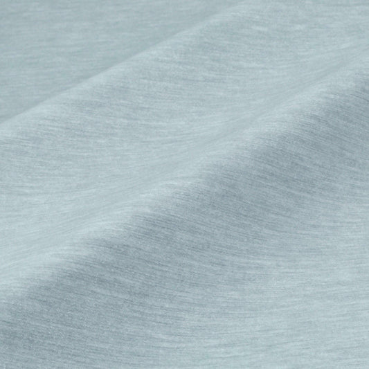 a close-up view of a textured fabric, possibly a piece of clothing or a textile. The fabric appears to be a light blue color, with a slightly wrinkled and folded appearance. The image does not contain any discernible objects or actions, and there are no specific actions or objects that can be described in detail.