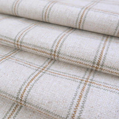May include: Close-up of a woven fabric with a plaid pattern. The fabric is primarily off-white with intersecting lines in shades of brown and gray, creating a grid-like design. The texture appears slightly uneven, suggesting a natural fiber material.