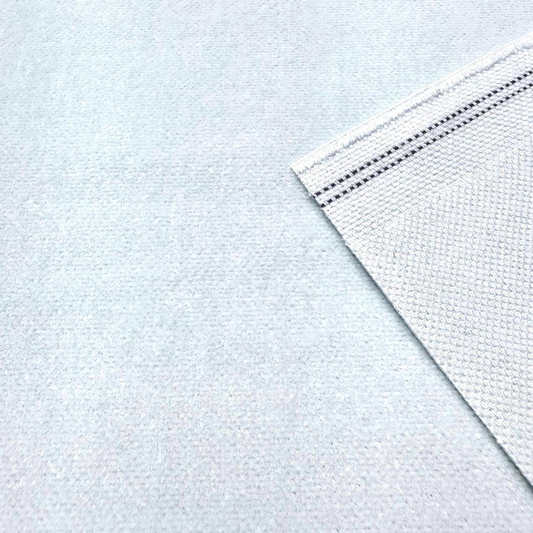 a close-up view of a white fabric with a black stripe running across it.