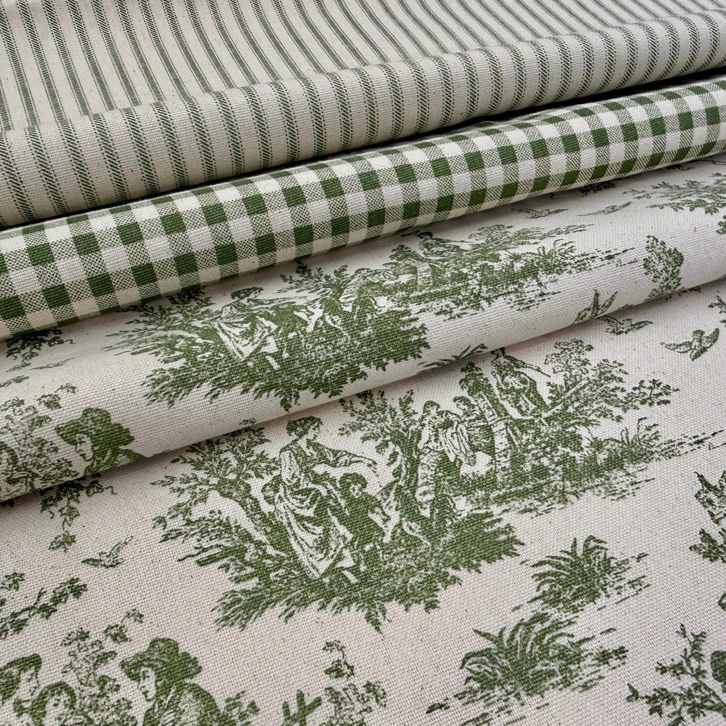a close-up view of a fabric with a repeating pattern of green and white checkered and floral designs.