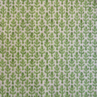 a repeating pattern of green leaves on a fabric surface.