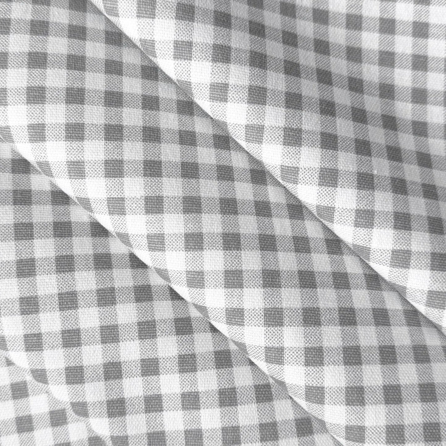 a close-up view of a fabric with a checkered pattern in shades of gray and white.