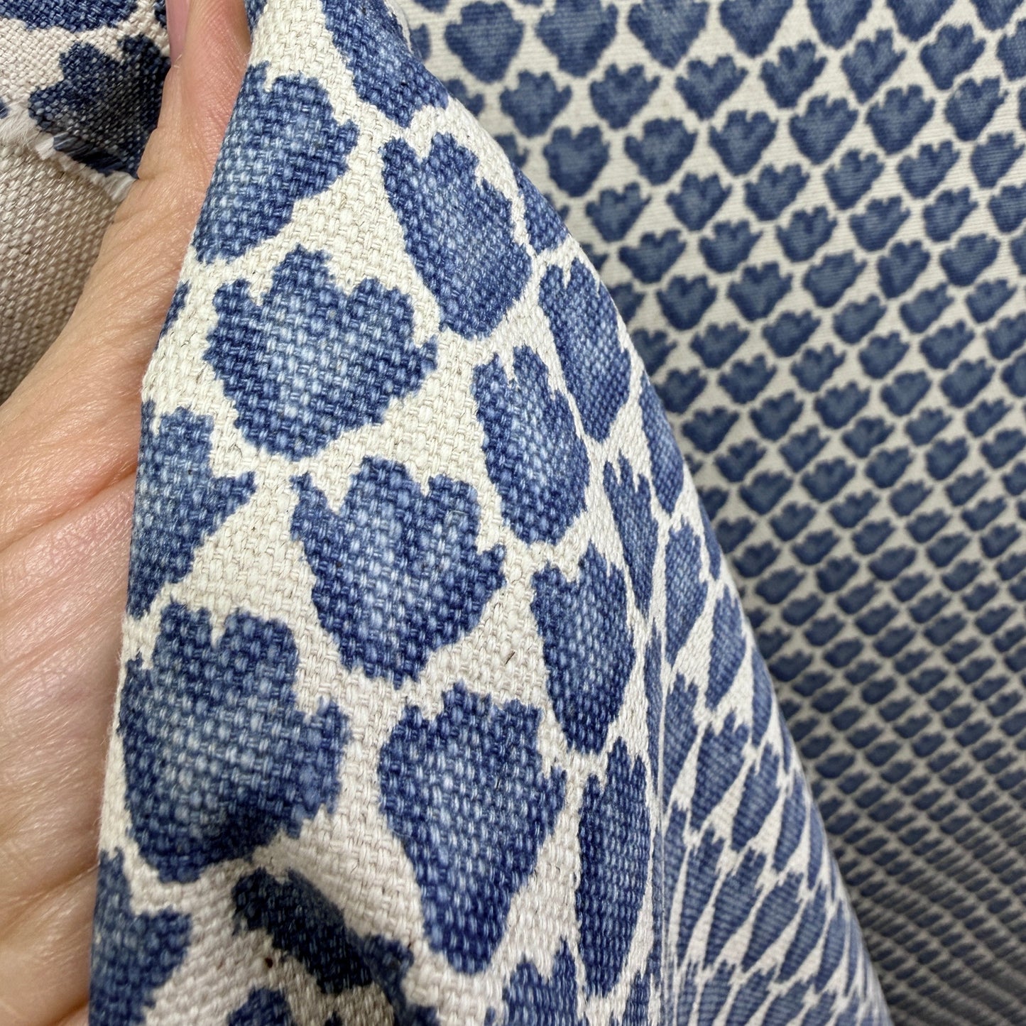 Close-up of blue block print fabric with small floral motif showing detail and weave