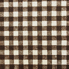 a close-up view of a fabric with a checkered pattern in shades of brown and white. A ruler is placed next to the fabric to provide a scale for size comparison.
