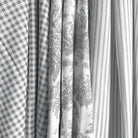 a close-up view of several fabric swatches, including a checkered fabric, a striped fabric, and a fabric with a floral pattern.