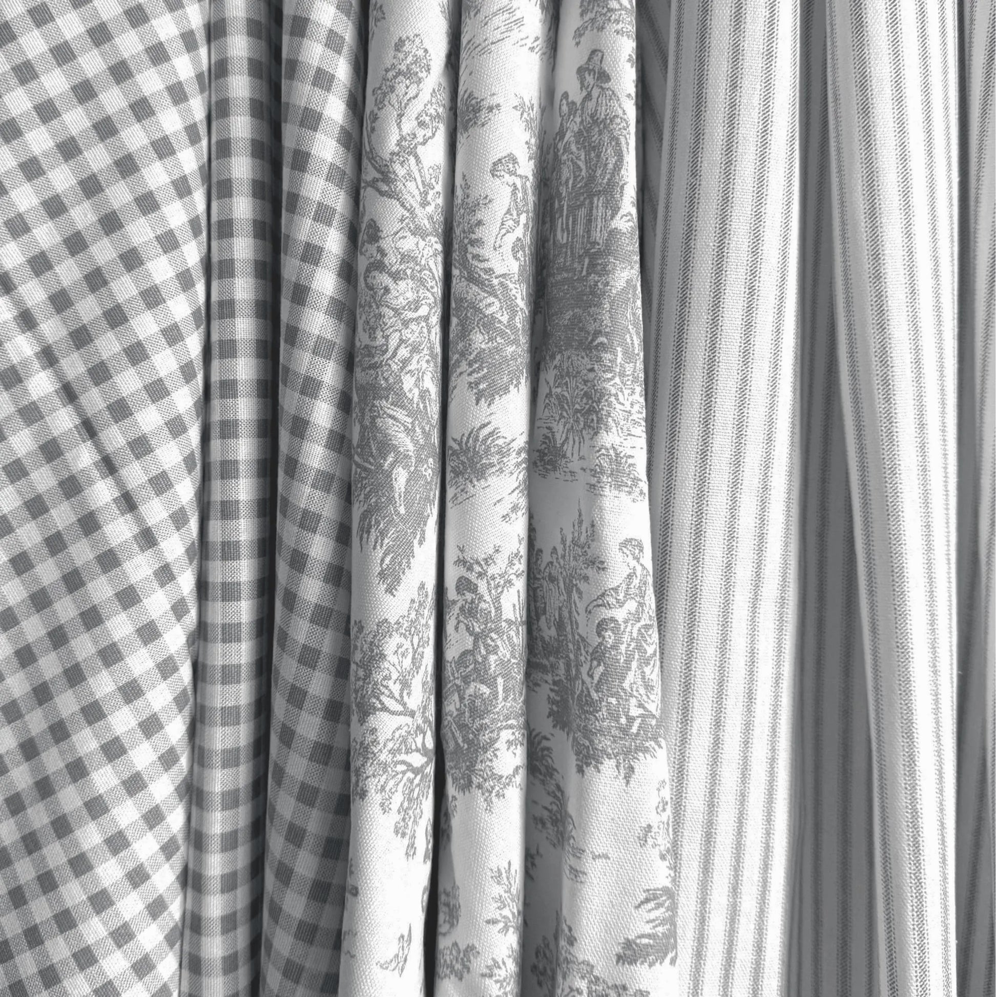a close-up view of several fabric swatches, including a checkered fabric, a striped fabric, and a fabric with a floral pattern.