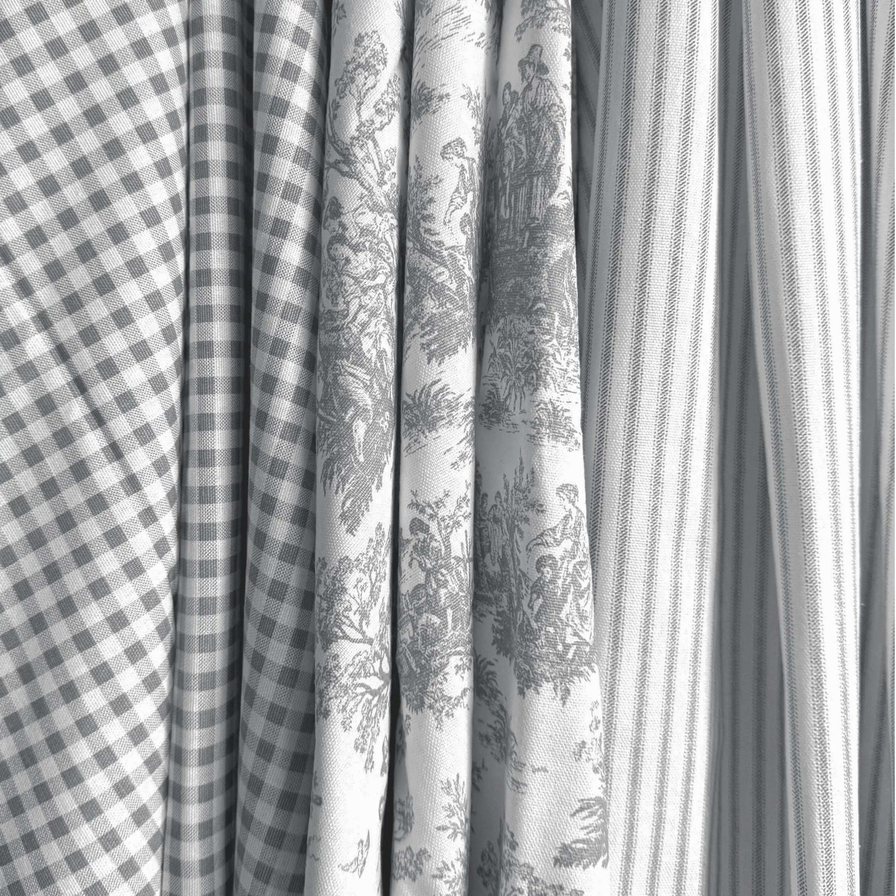 a close-up view of several fabric swatches, including a checkered fabric, a striped fabric, and a fabric with a floral pattern.