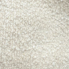 The image is a close-up of a fluffy, white, textured surface, possibly a carpet or a fabric.