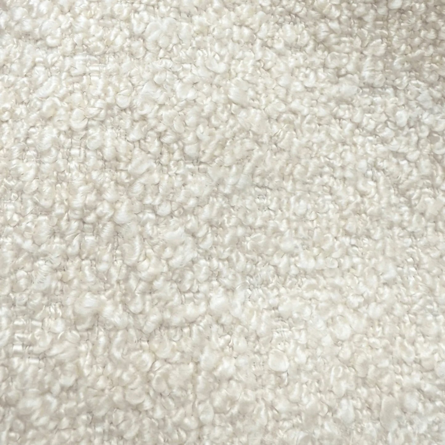 The image is a close-up of a fluffy, white, textured surface, possibly a carpet or a fabric.