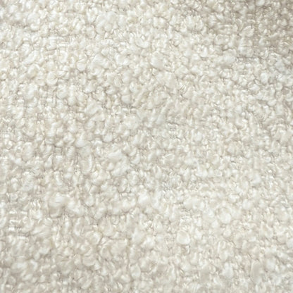 The image is a close-up of a fluffy, white, textured surface, possibly a carpet or a fabric.