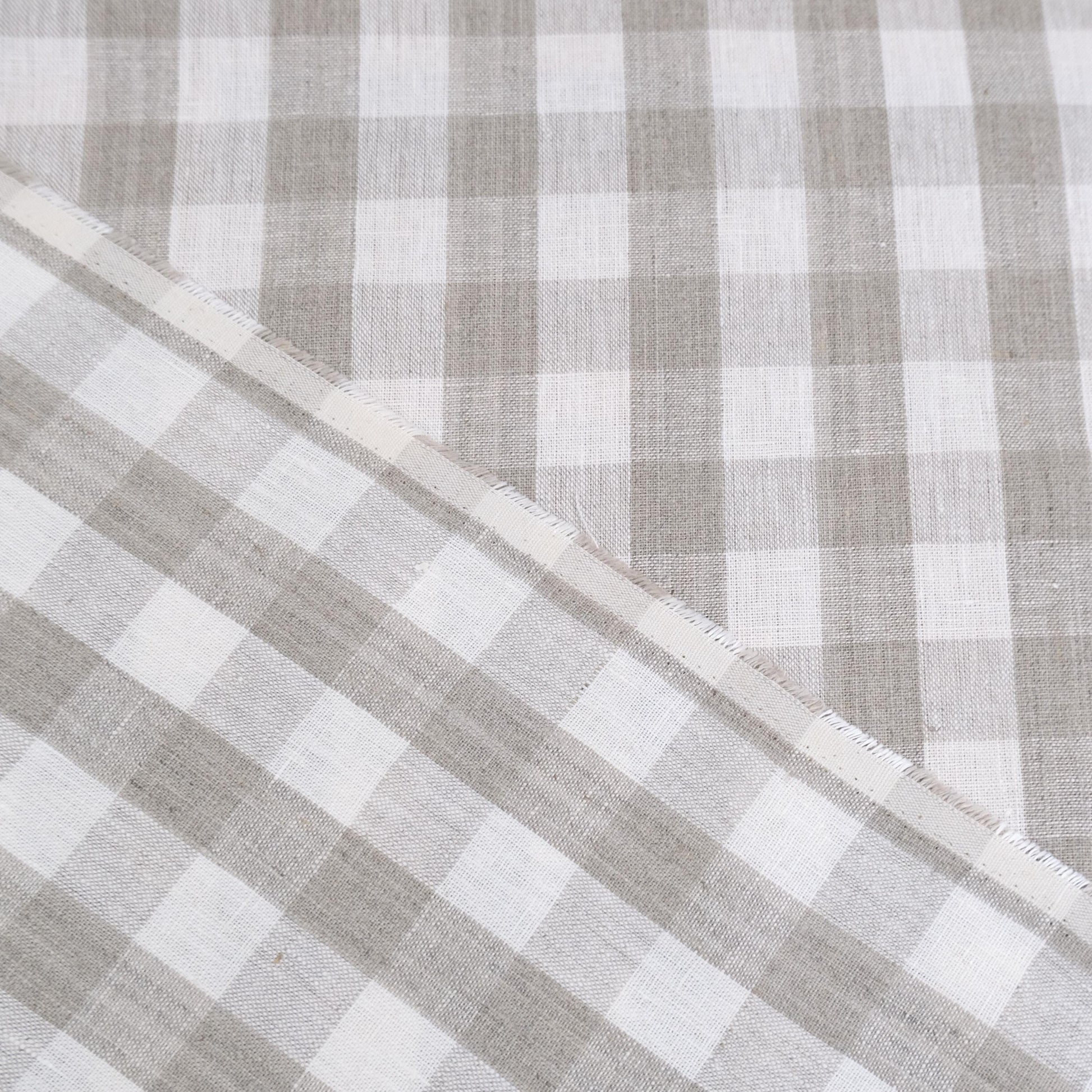Taupe gingham linen fabric rolled in drapery weight