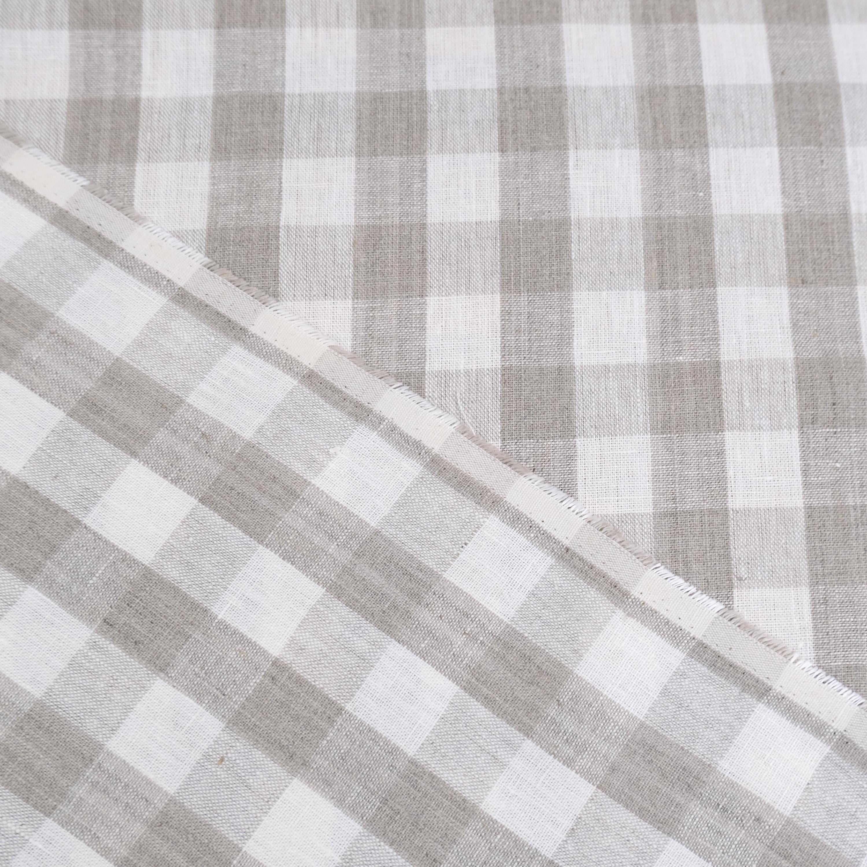 Taupe gingham linen fabric rolled in drapery weight