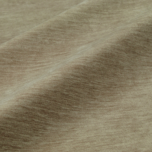 a close-up view of a textured fabric, possibly a piece of clothing or a textile. The fabric has a brownish-brown color and appears to have a slightly wrinkled texture.
