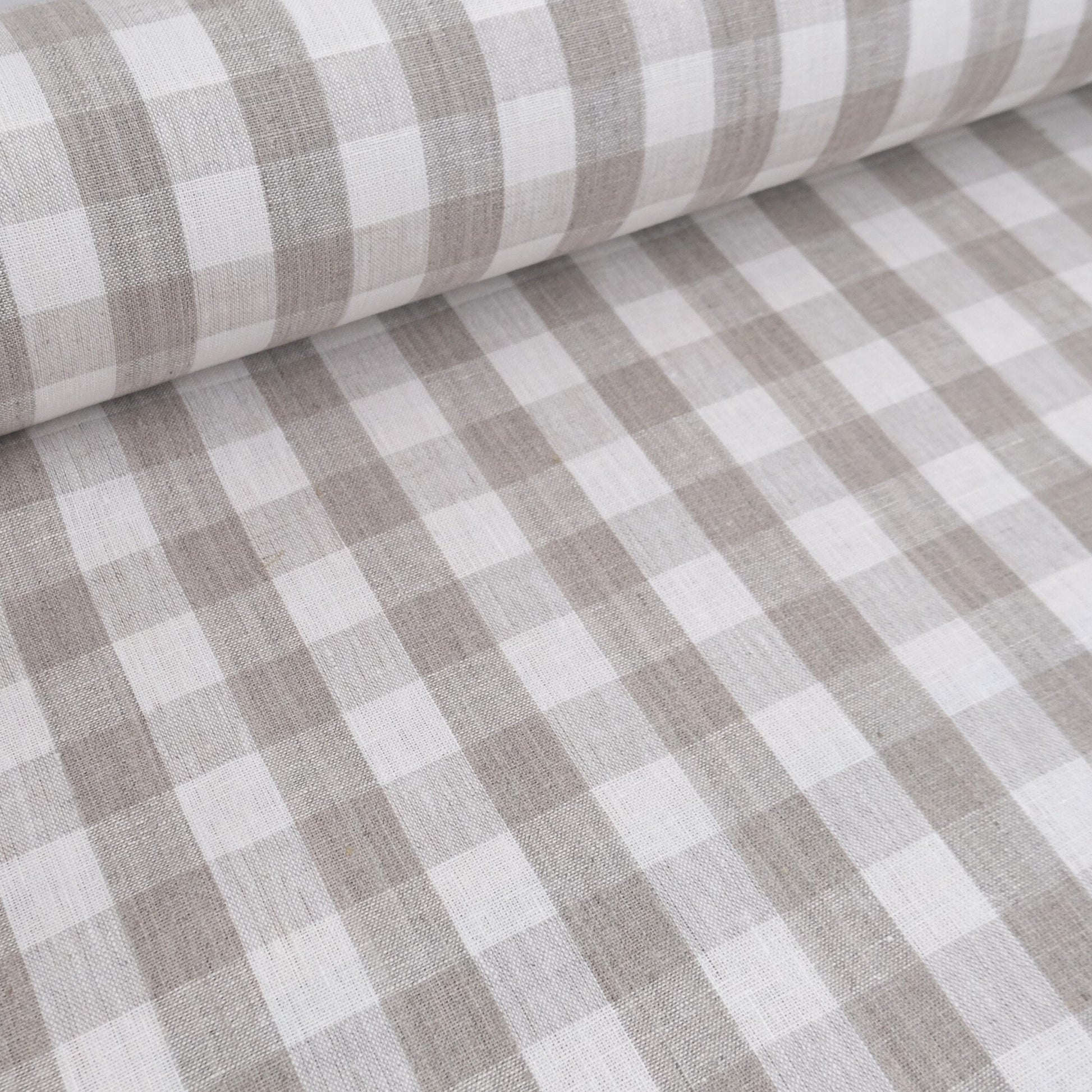Neutral checkered linen fabric draped for curtain sewing