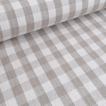 Neutral checkered linen fabric draped for curtain sewing