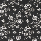 Close-up of black fabric with small white wildflower botanical print