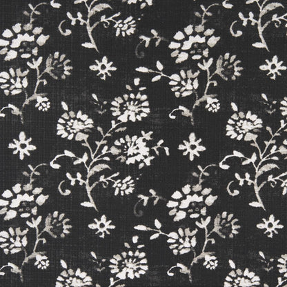 Close-up of black fabric with small white wildflower botanical print
