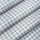 a close-up view of a fabric with a checkered pattern in shades of purple and white.