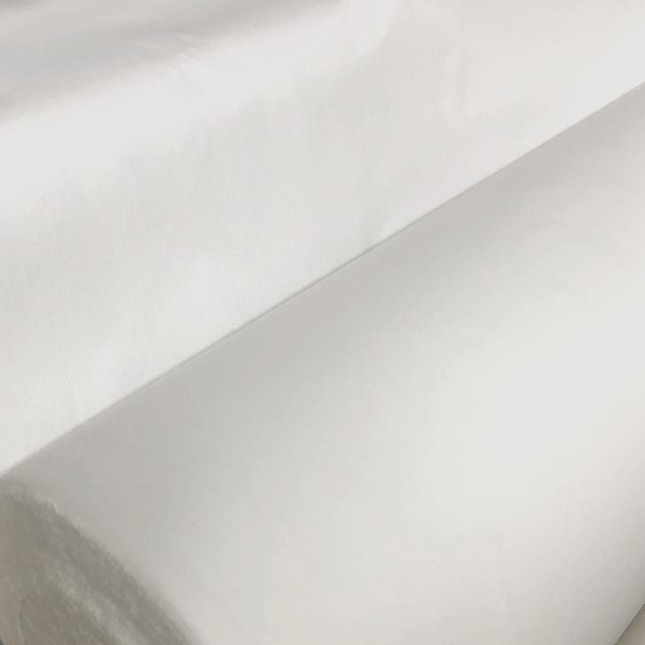 A large roll of white paper or fabric is shown in the image.