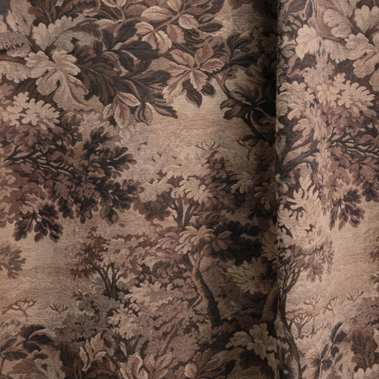 a close-up view of a fabric with a detailed, intricate floral pattern in shades of brown and beige. The pattern appears to be a tapestry or textile design, with the leaves and flowers arranged in a way that creates a sense of depth and complexity. The fabric's texture and color palette suggest it could be used for various purposes, such as clothing, home decor, or upholstery.