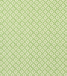 Fenwick Green quatrefoil trellis fabric by the yard in leaf green on cream, swatch with ruler