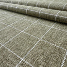 a close-up view of a woven fabric with a grid-like pattern of white lines, creating a textured and visually interesting surface.
