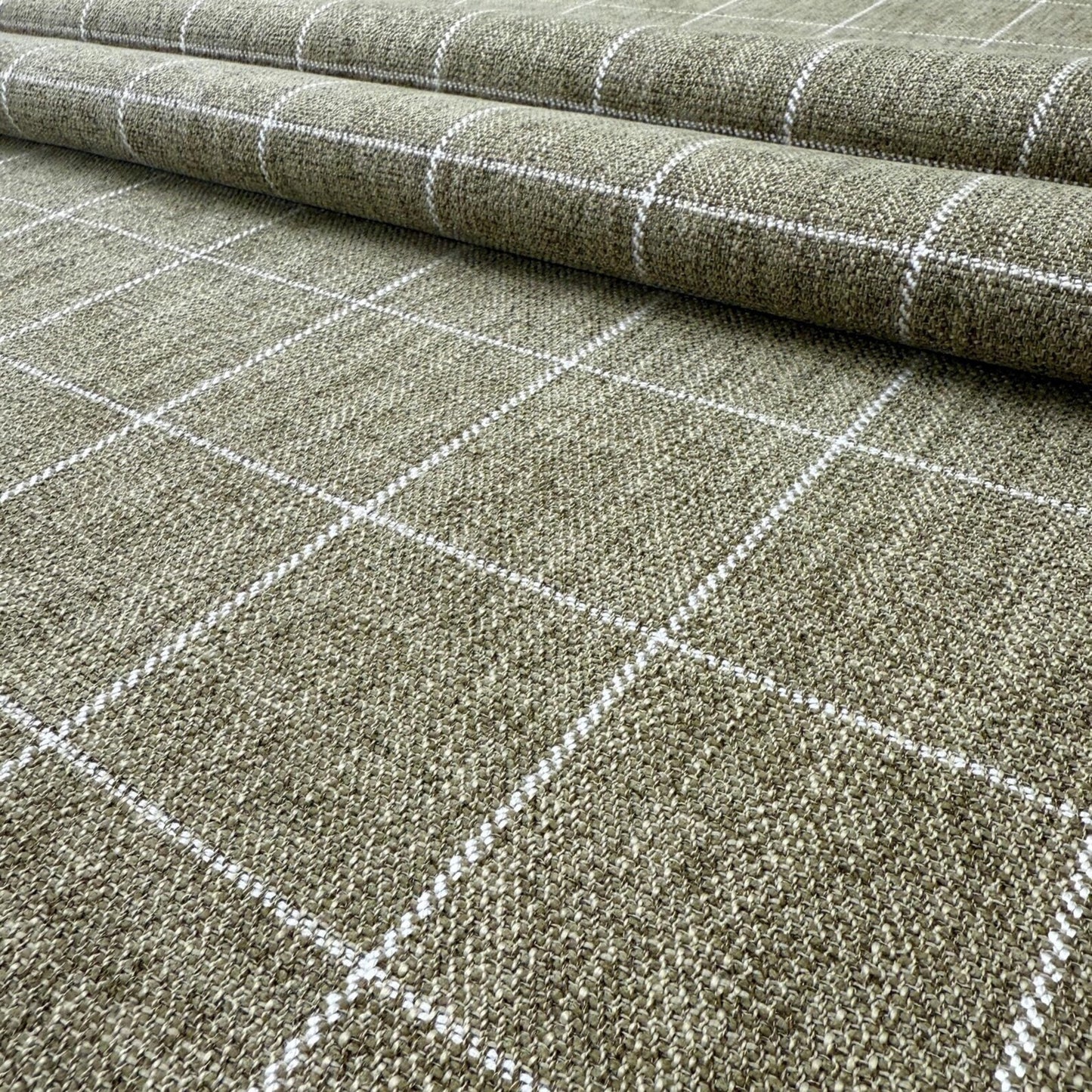 a close-up view of a woven fabric with a grid-like pattern of white lines, creating a textured and visually interesting surface.